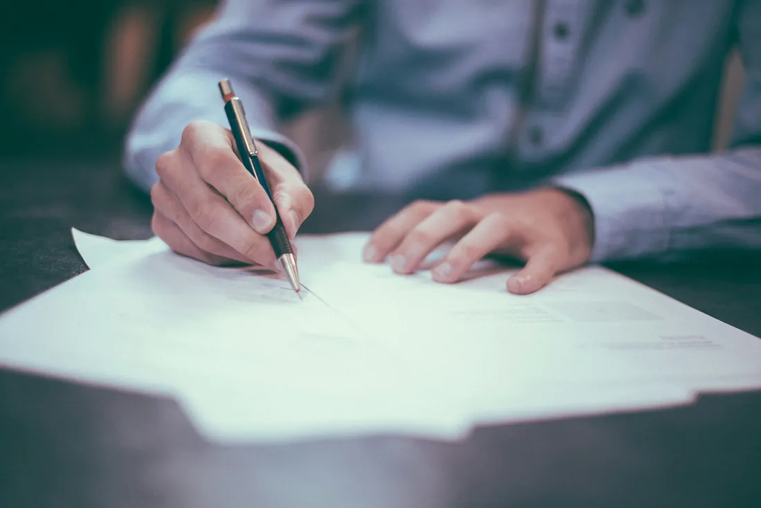 Person signing a document - inheritance and wills Person signing a document - inheritance and wills